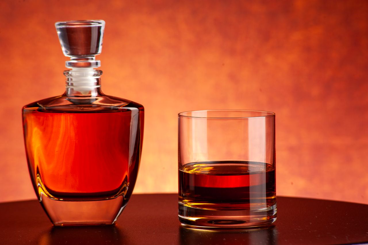 Luxurious whiskey decanter and glass set against a warm, inviting backdrop. Perfect for bars and homes.